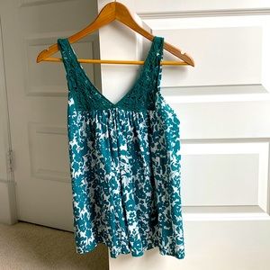 Cute summer top with lace embroidery. The pattern has flowers and vines.